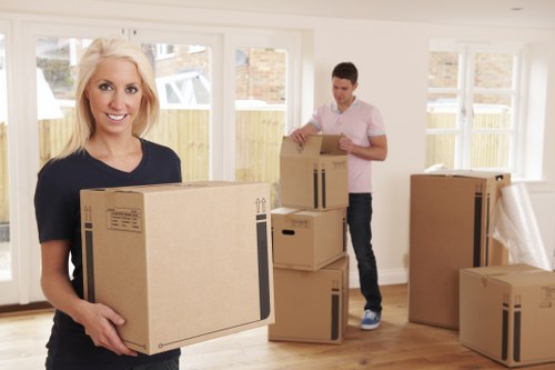Removal workers loading furniture for house removals in Thorntonheath
