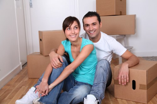 Professional movers handling packed boxes during a Thorntonheath removal