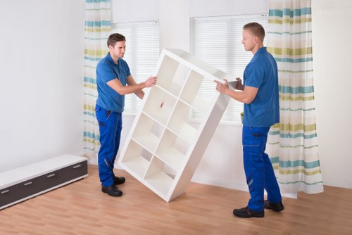 Professional man and van loading furniture for transport