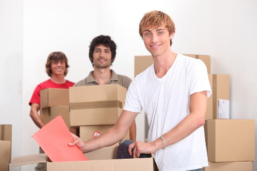 Local Thorntonheath removals team handling furniture in a residential street